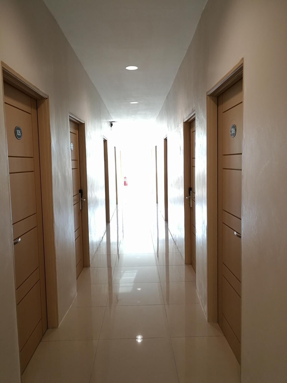 A hallway with doors numbered 105 and 106, leading to rooms.