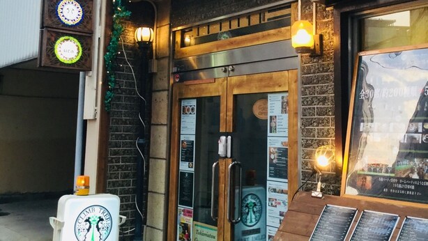 A cafe with a wooden facade, a glass door entrance, and a menu board outside. - Takamatsu Guesthouse BJ Station (Takamatsu)