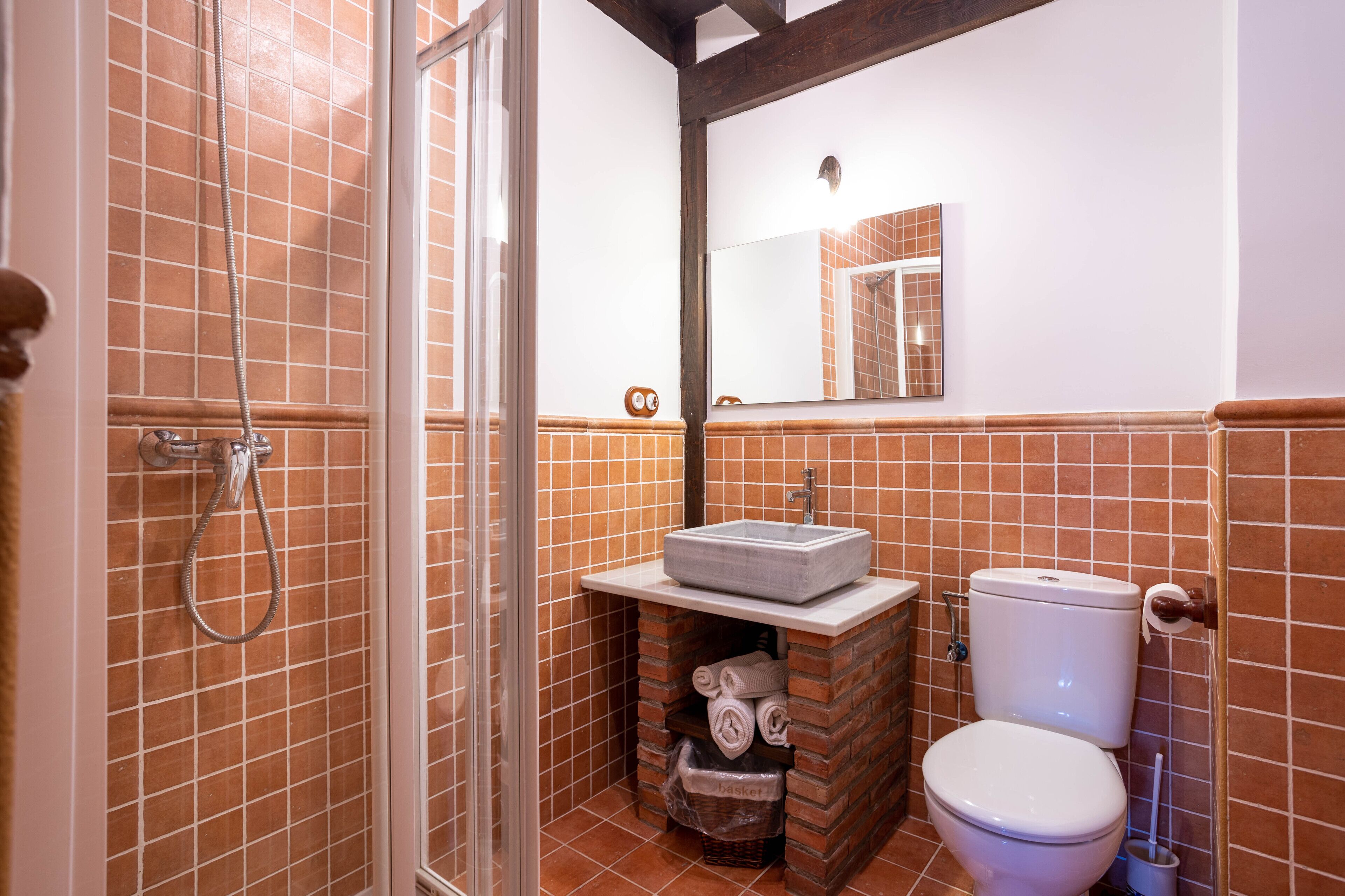 Un baño con ducha, lavamanos e inodoro.