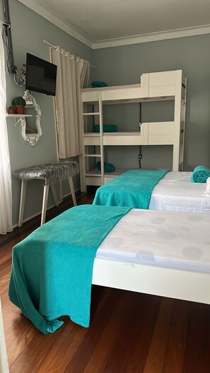 A room with bunk beds, a small stool, a television, and a mirror. - Hotel Cidade Imperial (Petrópolis)