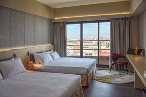 Deluxe Quadruple Room | Down comforters, desk, laptop workspace, blackout drapes