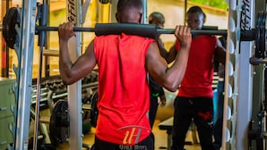 A gym with weightlifting equipment and a person performing a deadlift. - Utalii Hotel (Nairobi)
