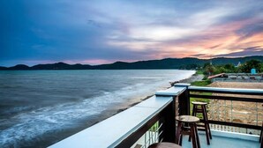 A seaside view from a balcony with a railing, overlooking a calm sea and distant mountains. - Kodtalay Resort (Tha Mai)