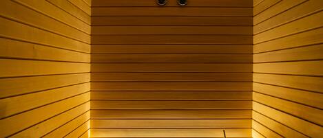 A sauna with wooden slats and a bench.