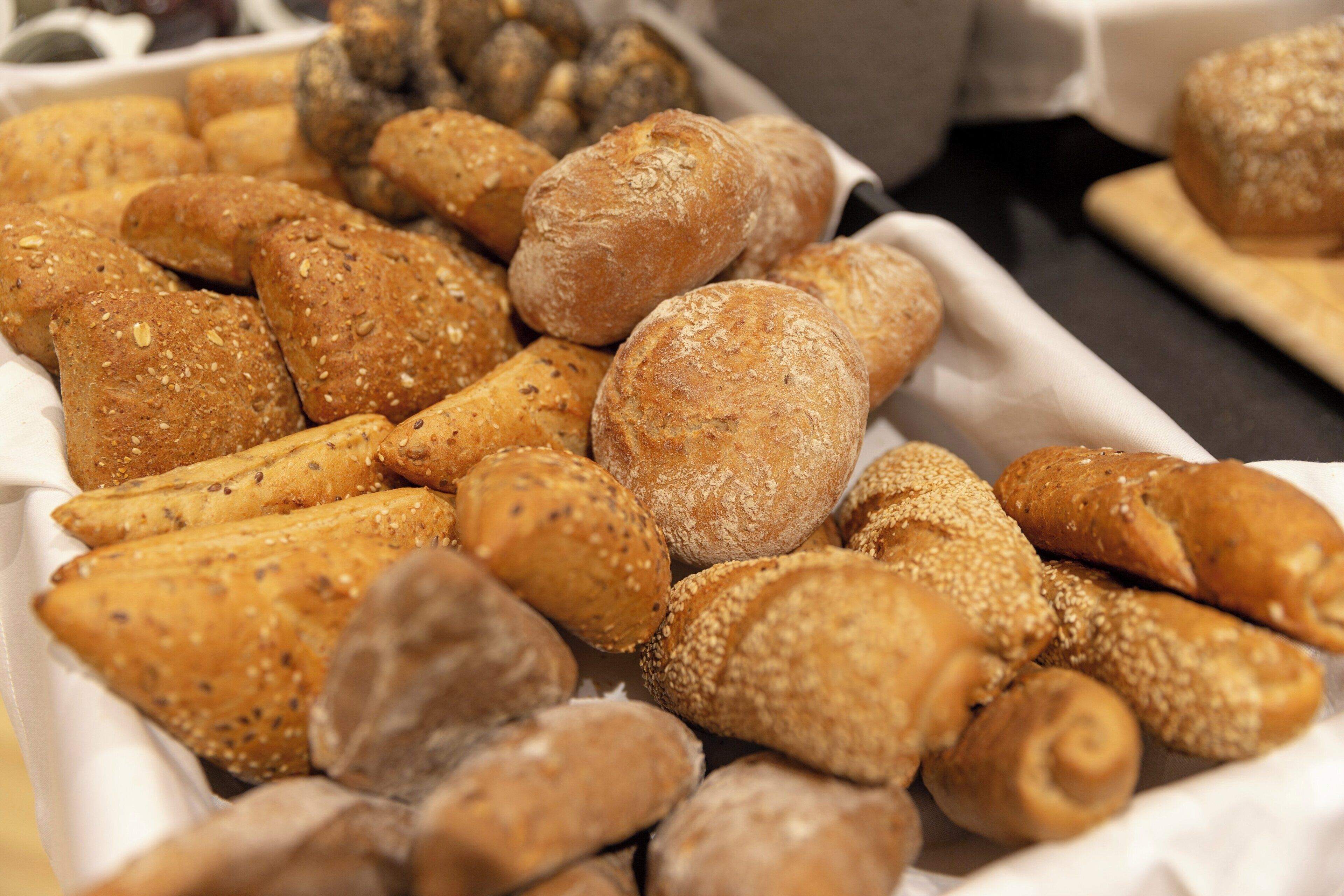 A variety of breads and pastries in a tray.