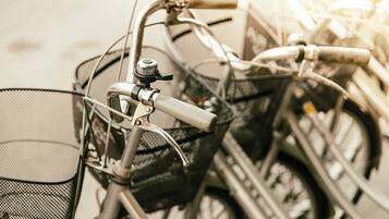 A close-up of a bicycle's handlebars and front basket.