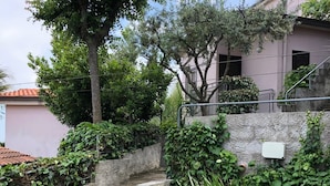 A stone staircase with steps leading up to a building, surrounded by greenery and a clear sky. - Villaggio Turistico Dea Cupra (Cupra Marittima)
