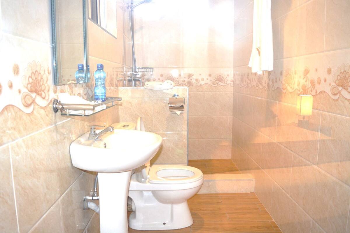 A bathroom with a sink, toilet, and shower.