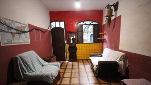 A small, dimly lit room with two beds, a map on the wall, and a tiled floor. - GoHouse Torre 16 (Rio de Janeiro)