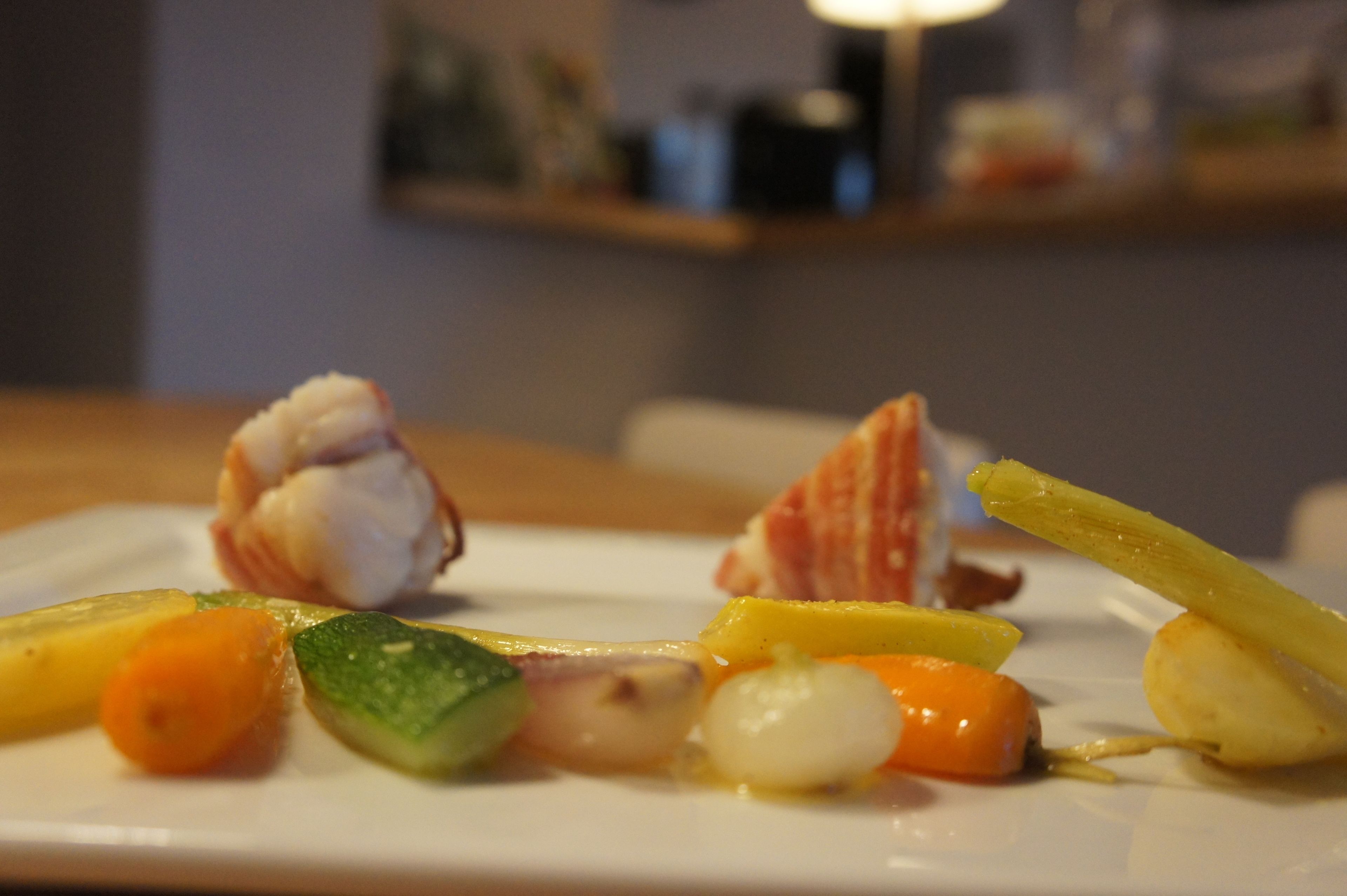 A plate of food with various vegetables and seafood.