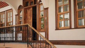 A staircase with ornate metal railings and wooden steps leading to an upper floor. - Melekli Konak (Amasya)