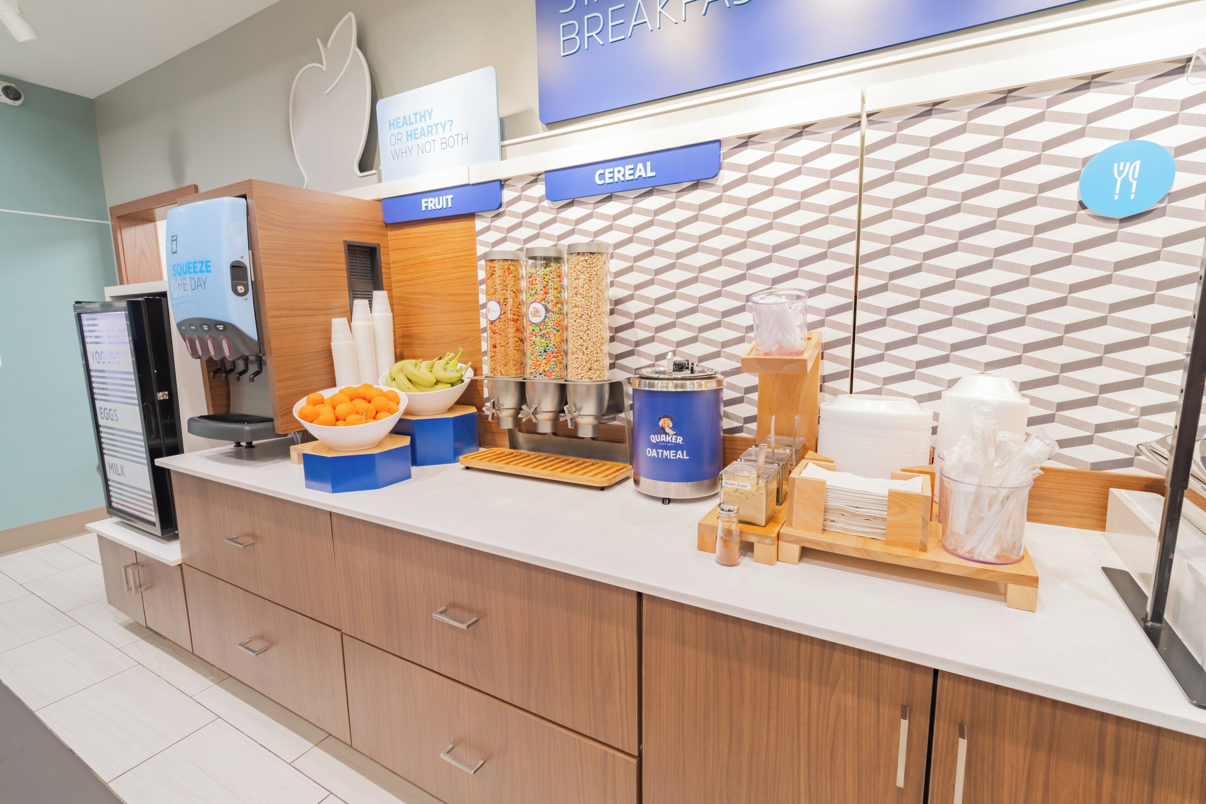 A breakfast bar with labeled sections for cereal, fruit, and eggs.