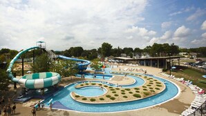 A water park with a large spiral slide, multiple swimming pools, and lounge areas with sunbeds. - Holiday Inn Express & Suites Marion by IHG (Marion)