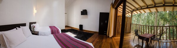 A bedroom with two beds, a black rug, a TV, and a balcony with a wooden railing. - Bamboo Lodge Sacred Valley (Pisac)