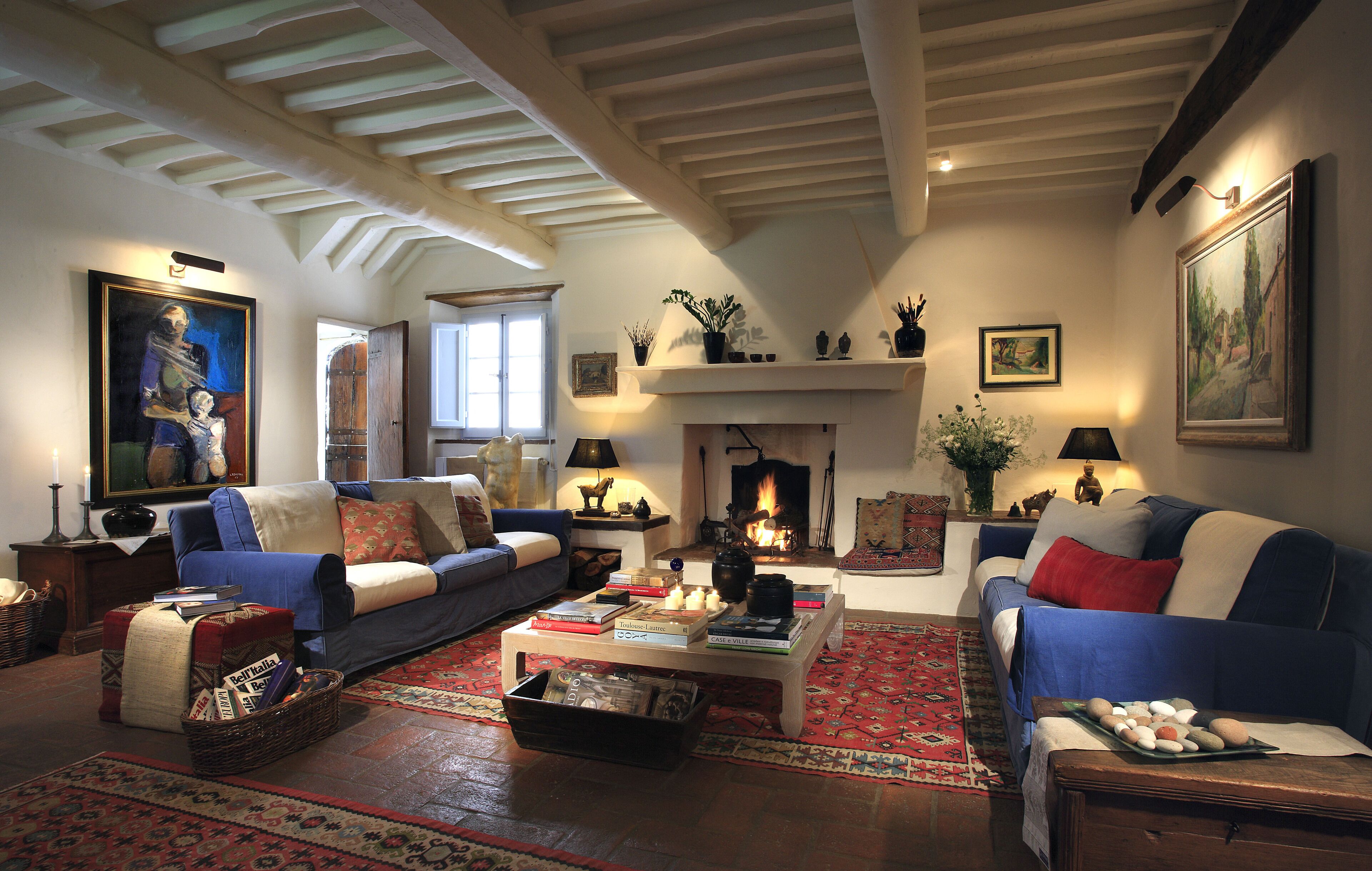 A traditional living room with a fireplace, sofas, and a coffee table.