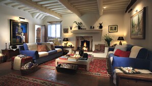 A cozy living room with a fireplace, sofas, and a coffee table.