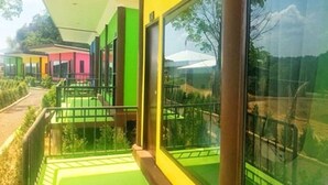 A modern building with large windows and a balcony. - T-House (Ratsada)