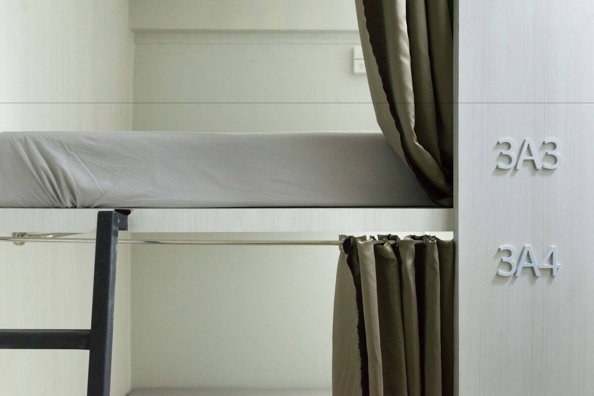 A bunk bed with curtains and room numbers 3A3 and 3A4.