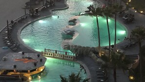 A resort pool area with multiple interconnected pools, lounge chairs, and palm trees. - As seen on HGTV! Sonoran Sea, Beach Front, Stunning Ocean Views,2B/2B, 8th Floor (Puerto Peñasco)