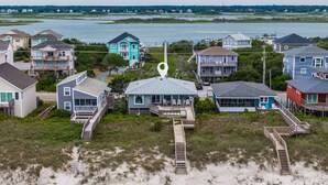 A coastal residential area with houses connected by walkways to the beach. - Loony Dunes | Direct Beach Access + Sound Front Dock (Topsail Beach)