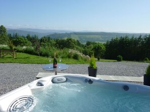 A hot tub with a clear view of a mountainous landscape. - Torran View (Inverness)
