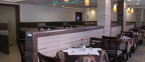 Un restaurante con cabinas, mesas y una decoración interior moderna.