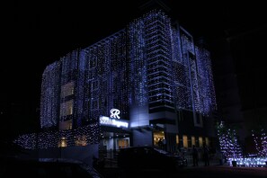 A hotel with a modern architectural design, featuring a prominent 'R' logo on the facade. - Hotel South Regency (Kanayannur)