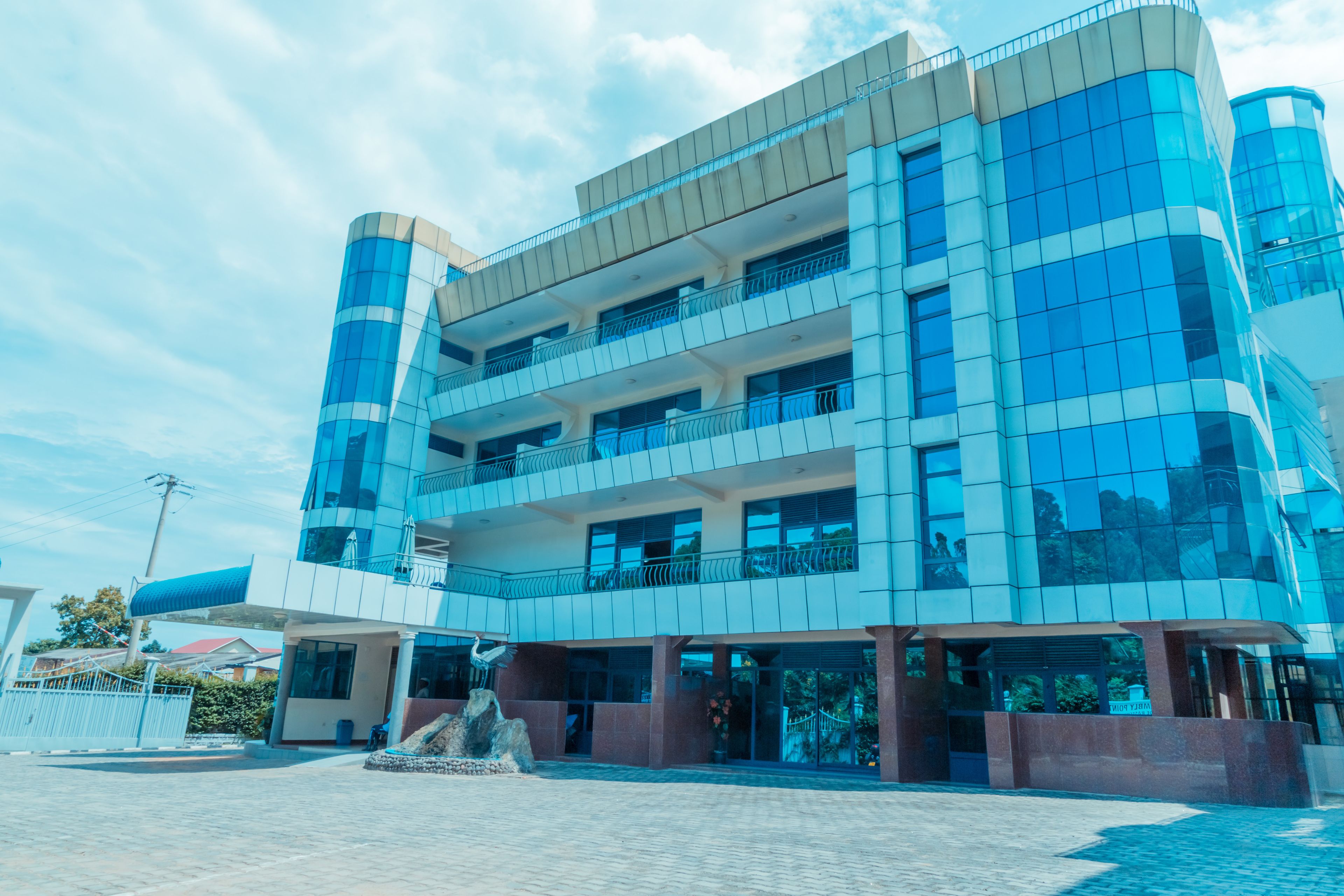 A multi-story building with a modern architectural design, featuring balconies and large windows.