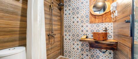A modern bathroom with a wooden shower enclosure, a patterned tile backsplash, and a wooden vanity with a sink.