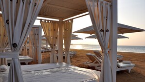 A beachside hotel with white canopies, sun loungers, and a bed with a white canopy. - KaiSol Romance Resort (Sahl Hasheeh)