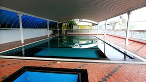 An indoor swimming pool with a tiled floor and a covered roof. - Ayur Bethaniya Ayurveda Hospital (Talappilly)