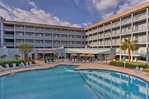 A hotel with a pool area, multiple balconies, and outdoor seating. - Ocean View, Pools: Hilton Head Resort: STR 072378 (Hilton Head Island)