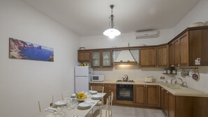 Une cuisine de taille réduite, dotée de meubles en bois, d’un four à micro-ondes et d’un évier.