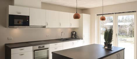 Fridge, stovetop, dishwasher, coffee/tea maker
