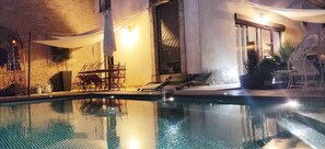 An infinity pool, pool loungers