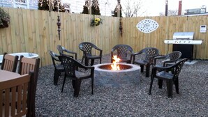 A patio area with a fire pit, outdoor seating, and a grill. - DOWNTOWN INDY HOME IN HISTORIC LOCKERBIE SQUARE  - 7 BLOCKS FROM CITY CENTER! (Indianapolis)