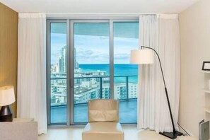 Enjoy a city view from the balcony, featuring a sofa and table.