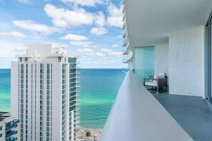 Enjoy breathtaking sea views from this hotel's spacious balcony with a seating area and glass railing.