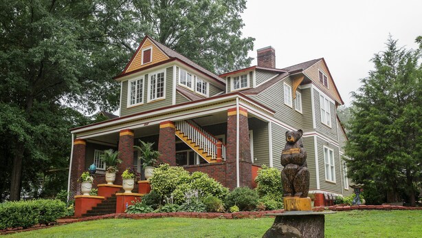 A large, two-story house with a prominent porch and a staircase leading to the upper floor. - Bear House 1890, Lilly's Loft, Delightful, Upgraded amenities, Walk to Cafes (Chattanooga)