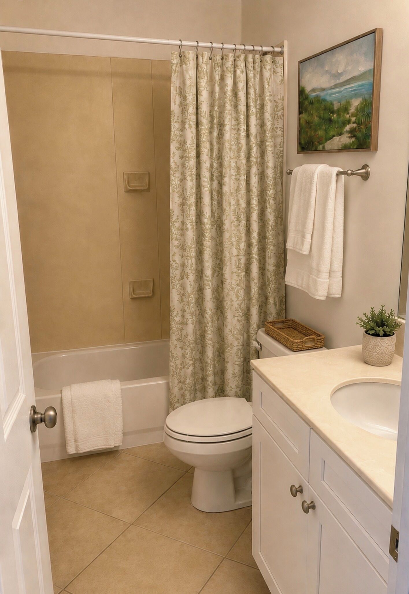 A bathroom with a shower, toilet, and sink.