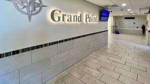 A lobby with a sign reading "Grand Pointe" and a compass logo. - Awesome Views!!! Watch the sail boats & seagulls. Two pools. Two hot tubs.
. (Orange Beach)