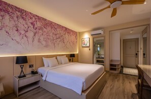 A modern hotel room with a large bed, bedside tables, a ceiling fan, and a wall-mounted air conditioning unit. - Palago Hotel, Binh Thanh District (Ho Chi Minh City)