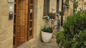 Ein rustikales Gebäude mit einer Holztür, einem Schild mit der Aufschrift 'Casa Laiglesia Turismo Rural' und einem Fahrrad davor.