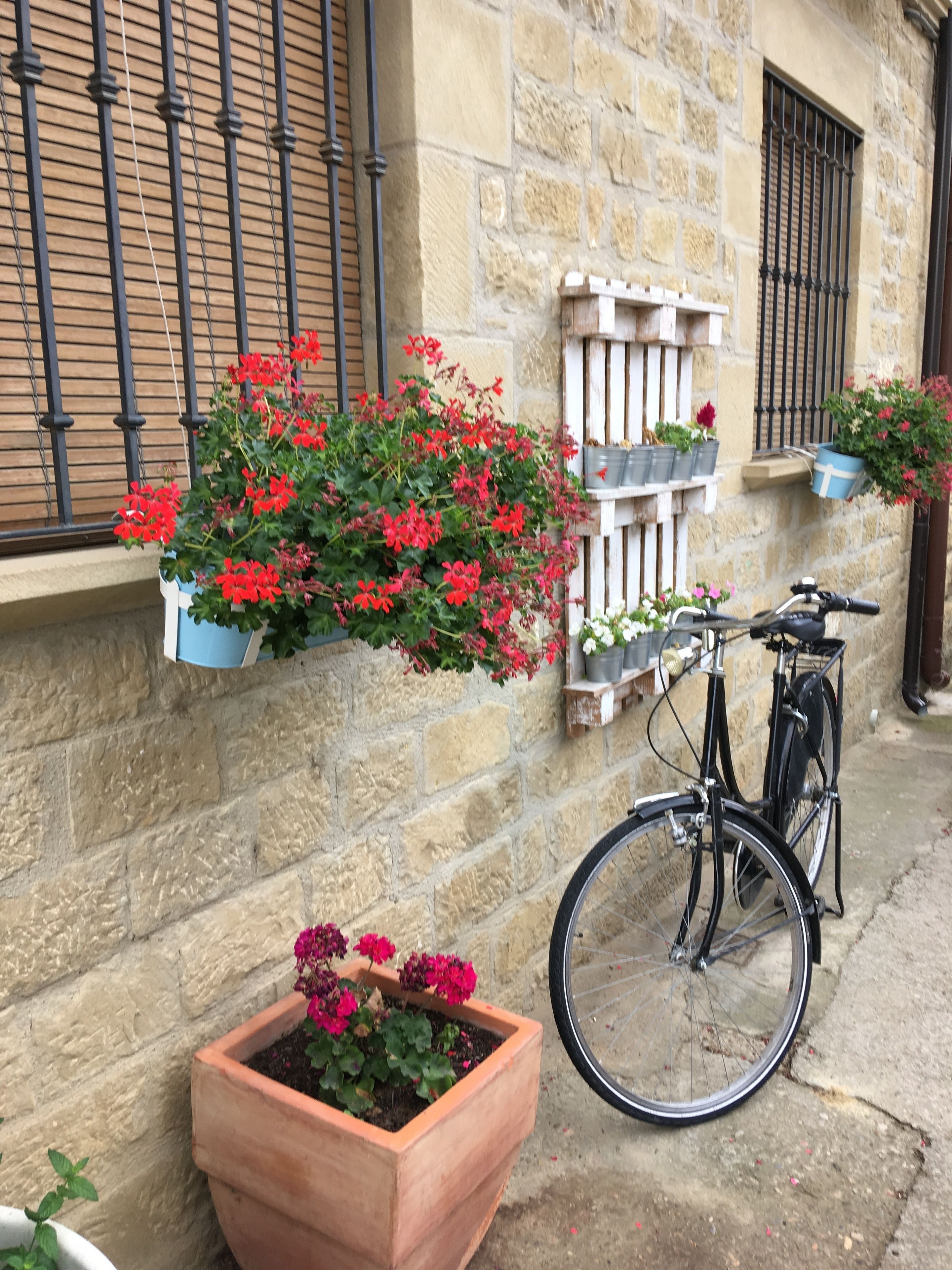 Un edificio de piedra con una bicicleta estacionada afuera.