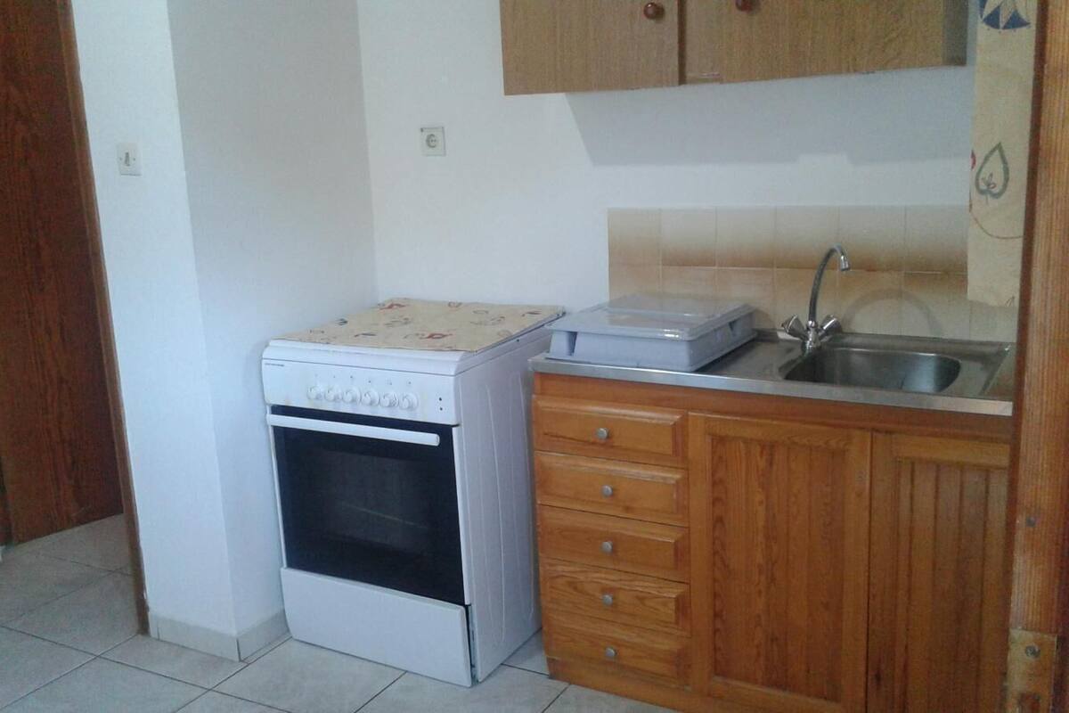 full-sized fridge, blender, cleaning supplies, paper towels