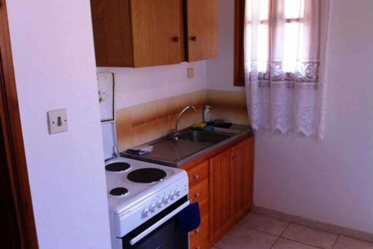 quadruple room, garden view | private kitchen | full-sized fridge, blender, cleaning supplies, paper towels