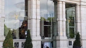A building with large windows, stone columns, and a crest above the entrance. - Faithlegg Lodge (Faithlegg)