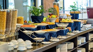 A buffet with various food items and a potted plant. - Hotel Sarowar Pokhara-Luxury Hospitality in the Heart of Pokhara (Pokhara)