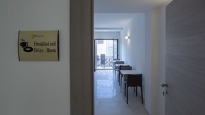 A hallway leading to a dining area with a sign indicating a 'Breakfast and Relax Room'. - TH Collection Rooms (Oristano)
