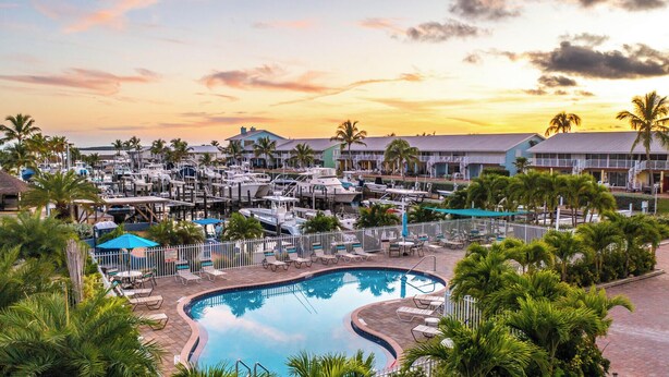 A marina with boats, a swimming pool, and resort buildings. - Penthouse Apartment Sunsets in Key Largo, Kawama Yacht Club Tower (Key Largo)